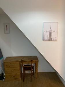 a table with a chair and a desk under a staircase at Lovely 2 Bedroom Apartment with free parking in Manchester