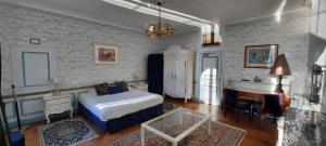a bedroom with a bed and a desk and a piano at Domaine De Moresville in Flacey