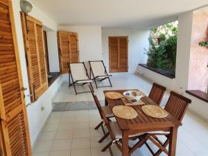 a dining room with a wooden table and chairs at Giulianahouse in La Maddalena