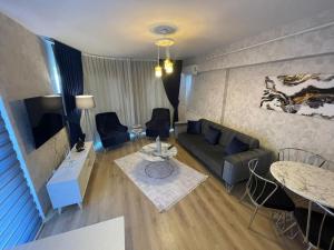 a living room with a couch and a tv and a table at King Suite SS7 in Istanbul