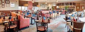 a restaurant with tables and chairs in a room at Fell View in Troutbeck