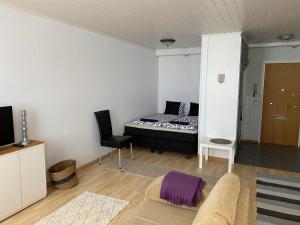 a living room with a bed and a couch at Apartment Isokatu in Kokkola