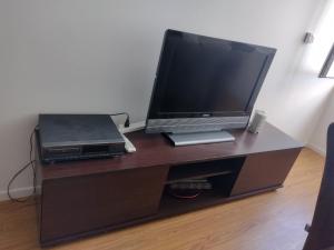 a tv sitting on a desk with a laptop at Departamento Bahía Grande in Ushuaia