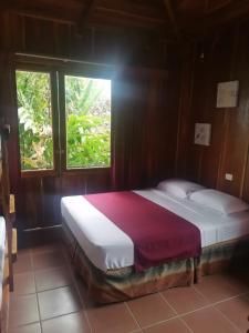 a bed sitting in a room with a window at Villas Josipek in Fortuna