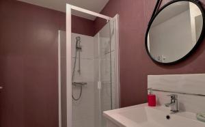 a bathroom with a shower and a sink and a mirror at Chambres d'Hôtes Les Fleurettes en Baie Du Mont Saint Michel in Saint-Marcan