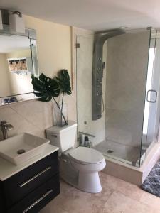a bathroom with a shower and a toilet and a sink at Homestay Weston Ranches in Southwest Ranches
