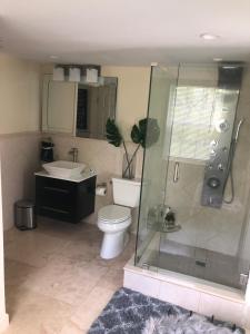 a bathroom with a toilet and a shower and a sink at Homestay Weston Ranches in Southwest Ranches