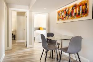 a dining room with a table and chairs and a bedroom at ENTIRE 2 BEDROOM APARTMENT DOWNTOWN - u1 in Kitchener