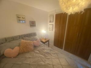 a bedroom with a bed with a stuffed animal on it at Sunny rhyl apartment in Rhyl