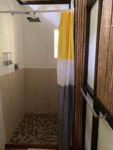 a shower with a colorful shower curtain in a bathroom at Pequeño Paraiso 1 in Punta Uva