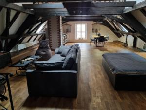 a living room with a couch and a table at Galerie Vila Lucia 5 -Loft apartmán in Plzeň