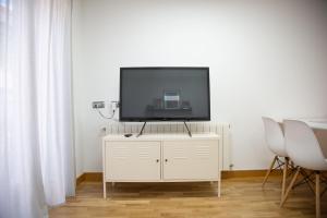 a flat screen tv on top of a white cabinet at ELIZABETH TOWERS in Almansa