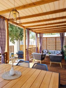 d'une terrasse avec une table et des chaises en bois. dans l'établissement Bungalow Home Sweet Home - Logement complet, à Biograd na Moru