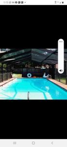 a large blue swimming pool with a sign on it at A Touch of Madagascar in Fort Walton Beach with HEATING POOL in Fort Walton Beach