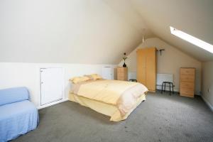 a bedroom with a large bed in a attic at London comfy doubles in London