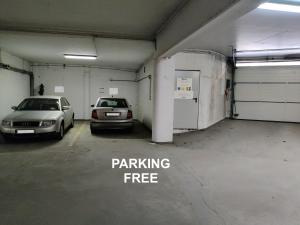 a parking garage with two cars parked in it at Szarotka II in Szczecin
