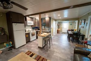 a kitchen and living room with a white refrigerator at Roscoe Cottage Pet Friendly in Roscoe