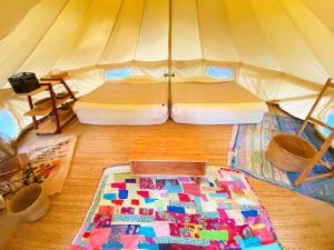 a bedroom with a bed in a tent at RAINBOW FOREST Permaculture filed - Vacation STAY 13693v in Ibaruma