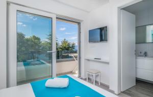 a bedroom with a large glass door leading to a balcony at Luxury Apartments Villa Lučica in Malinska