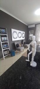 a rendering of a living room with a white mannequin in a room at V's studio in Ballito