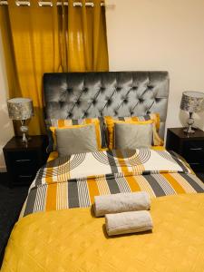 a bedroom with a large bed with two towels on it at City Blessed Aptm 3 with Free Parking in North Shields +4 photos