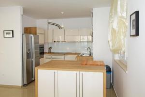 a kitchen with white cabinets and stainless steel appliances at Appartement A6 - Private Pool & Sea View in Bol