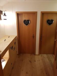 a room with two doors with hearts on them at Ferienwohnung Weber Alpenveilchen in Lechbruck