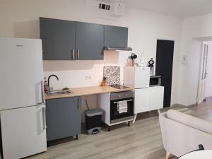 a kitchen with white cabinets and a wooden counter top at TERRASSE du GET in Revel