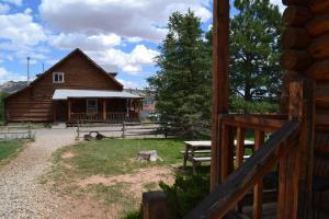 a log cabin with a picnic table in front of it at Escalante Outfitters in Escalante