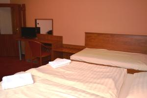 Voodi või voodid majutusasutuse Hotel Koruna toas