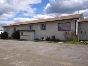 a large building with a parking lot in front of it at Nisutlin Trading Post Motel in Teslin
