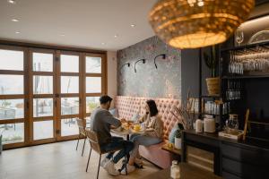 a man and woman sitting at a table in a restaurant at Hotel Abaco Altea in Altea