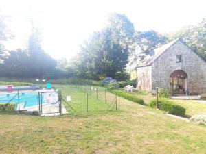 a barn with a pool in front of a yard at Gîte La Grange in Langoëlan +67 photos