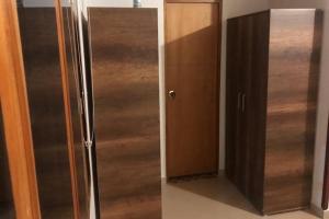 a stainless steel refrigerator next to a wooden cabinet at Cabañas San Miguel Arcángel in San Gil