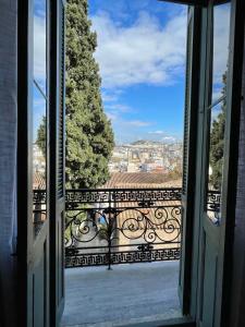 an open window with a view of a city at Acron Athens in Athens