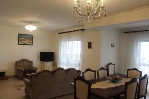 a living room with a couch and a table and a chandelier at Ocean Drive / Vista mar apartment in Vieira de Leiria