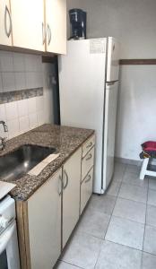a kitchen with a sink and a refrigerator at AGRADABLE STUDIO EN PALERMO in Buenos Aires +4 photos