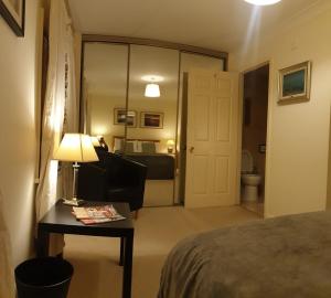 a bedroom with a bed and a table with a lamp at Double room with bathroom in central London - Vauxhall in London