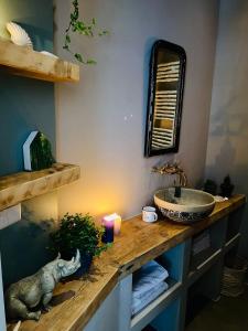 a bathroom with a sink and a counter with a candle at Tiny Beachhouse in Scheveningen