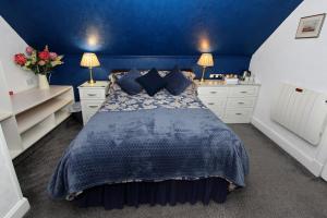 
a bedroom with a bed and a dresser at Braeside Guest Rooms in Portree
