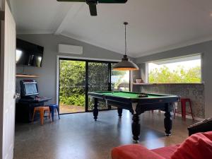 a living room with a pool table in it at The Bird House in Mount Tamborine