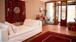 
a living room filled with furniture and a white couch at Kkala Boutique Hotel in Salta
