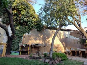 a backyard with a table and chairs and trees at Mondrian Santiago in Santiago