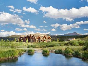 a lodge with a river in front of it at Hyatt Vacation Club at The Ranahan in Breckenridge