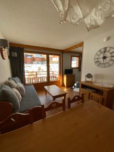 a living room with a couch and a table at Residence la Dame Blanche 1800 in Puy-Saint-Vincent