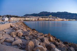a group of rocks on the shore of a body of water at Gran H La Marina in Altea