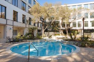 a swimming pool in front of a building at Sonder at South Congress in Austin