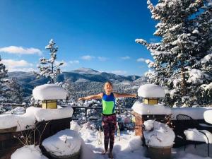 a young boy standing on top of a snow covered mountain at Boulder Best City and Nature with Lake and Trails PETS OK in Boulder