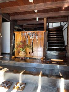 a group of shoes in a room with a staircase at 宿屋白金家 yadoya-shiroganeya 1日1組限定2名から8名様まで 全館貸切り 伝統的建造物の旅籠宿 Traditional culture experience in Nagano