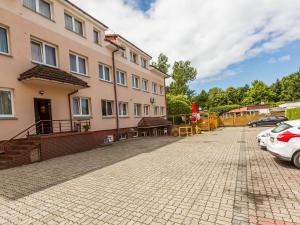 a parking lot in front of a building at Hotel Sport in Koszalin